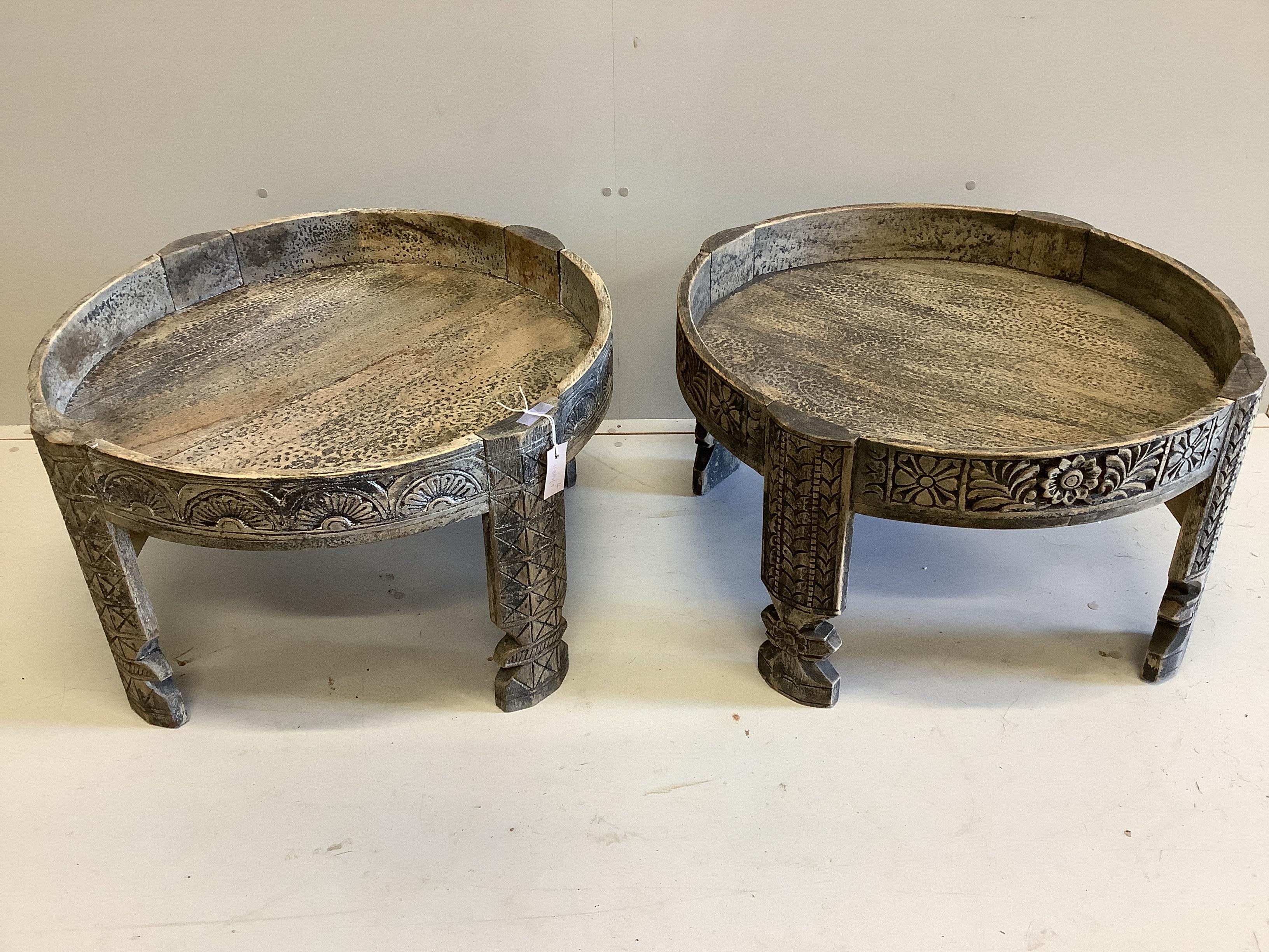 A pair of African circular carved hardwood tables, diameter 50cm, height 45cm